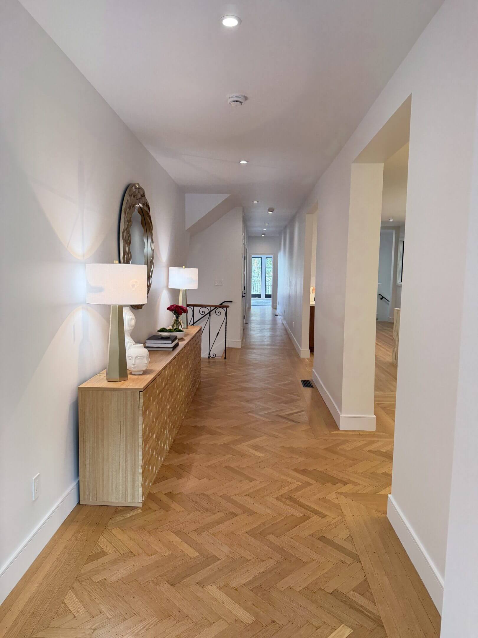 Bright hallway with wooden flooring and sideboard.